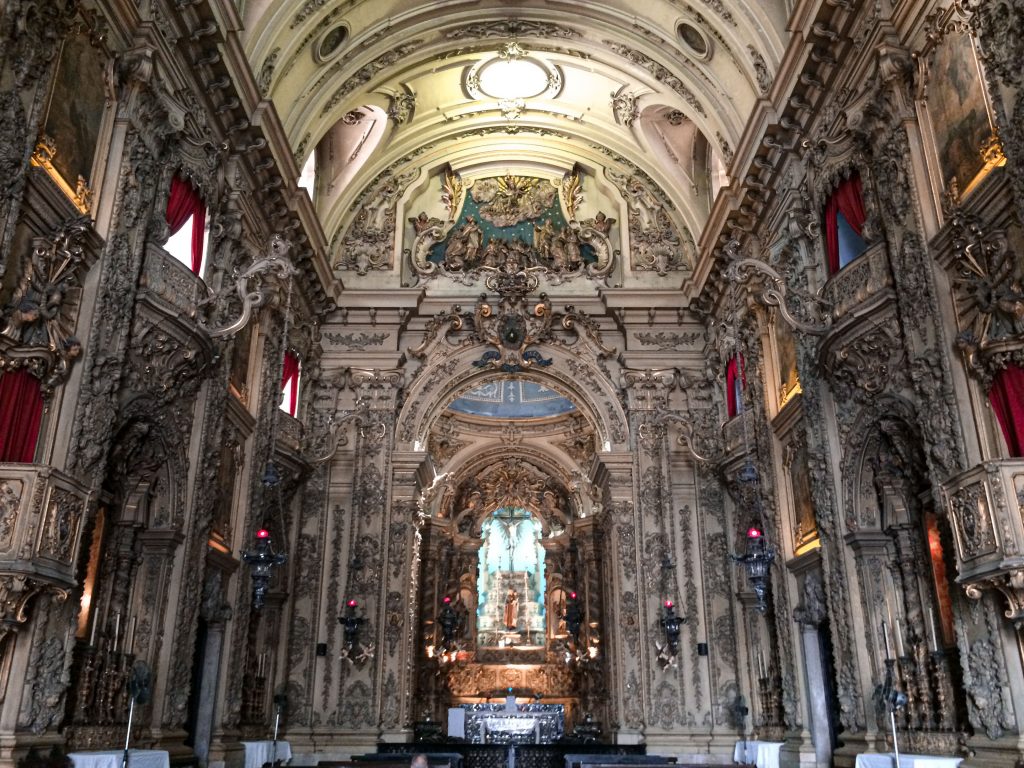 pexels-photo-6205890-6205890 Intricate baroque interior of a historic church in Rio de Janeiro, showcasing majestic architecture and rich detail.
